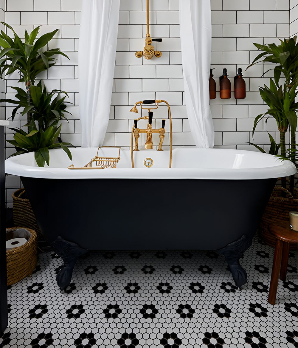 Black roll-top bath on a black and white hexagon mosaic floor