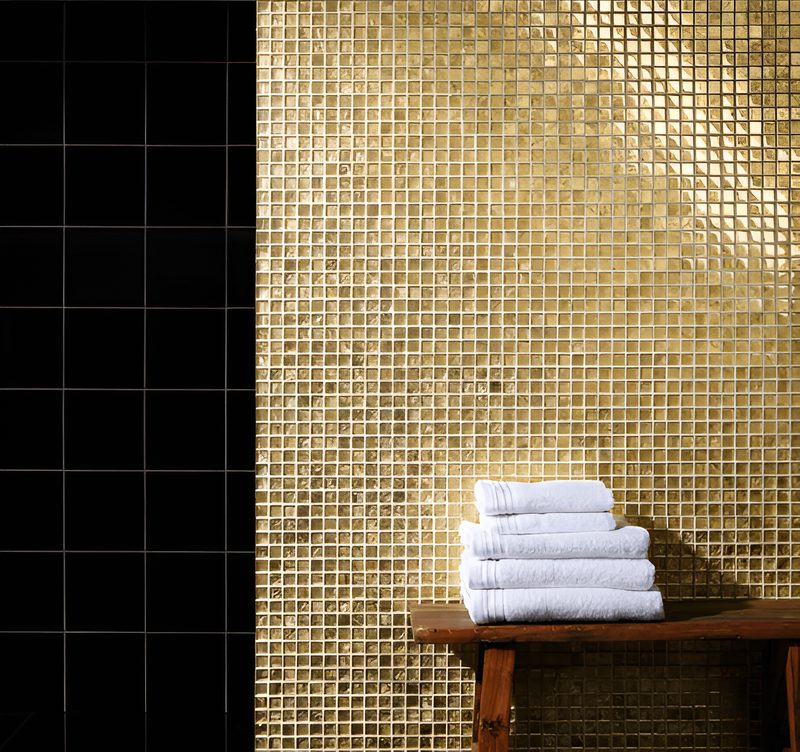 Gold glass mosaic feature wall in a bathroom