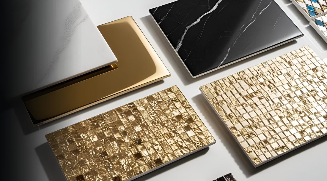Gold, marble and black tile samples laid out on a table